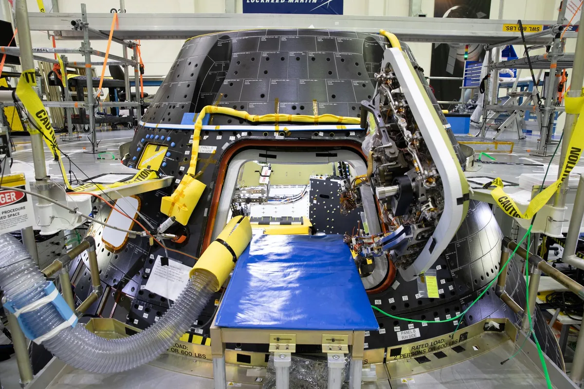 A wider group shot of the Artemis II crew with Exploration Ground Systems.