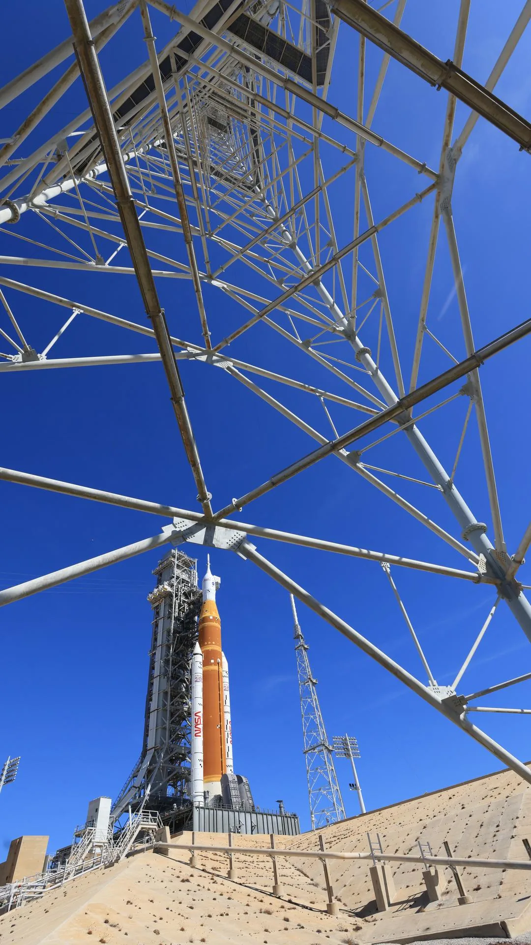 A wide photograph of Artemis II at the launch pad.